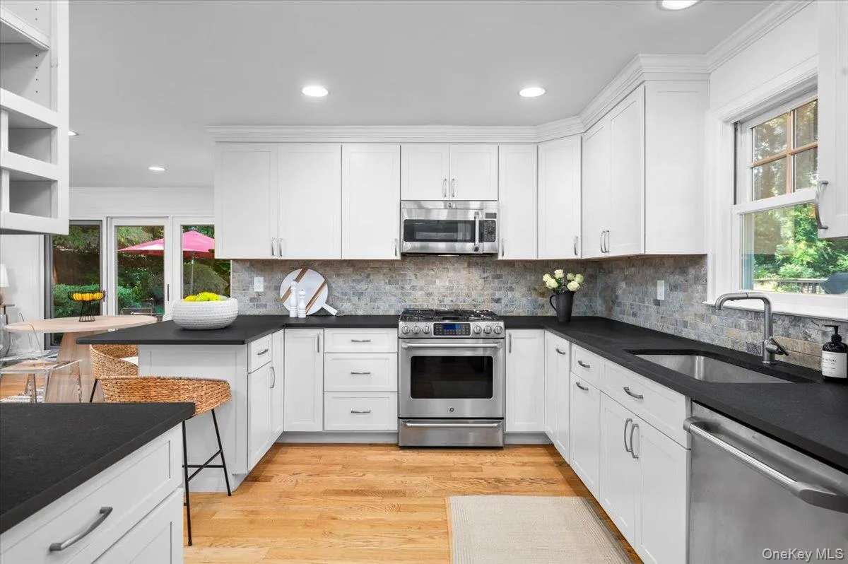 Abundant cabinetry and expansive work surfaces make this kitchen as practical as it is polished, with stainless steel appliances and recessed lighting completing the space. Abundant cabinetry and expansive work surfaces make this kitchen as practical as it is polished, with stainless steel appliances and recessed lighting completing the space.