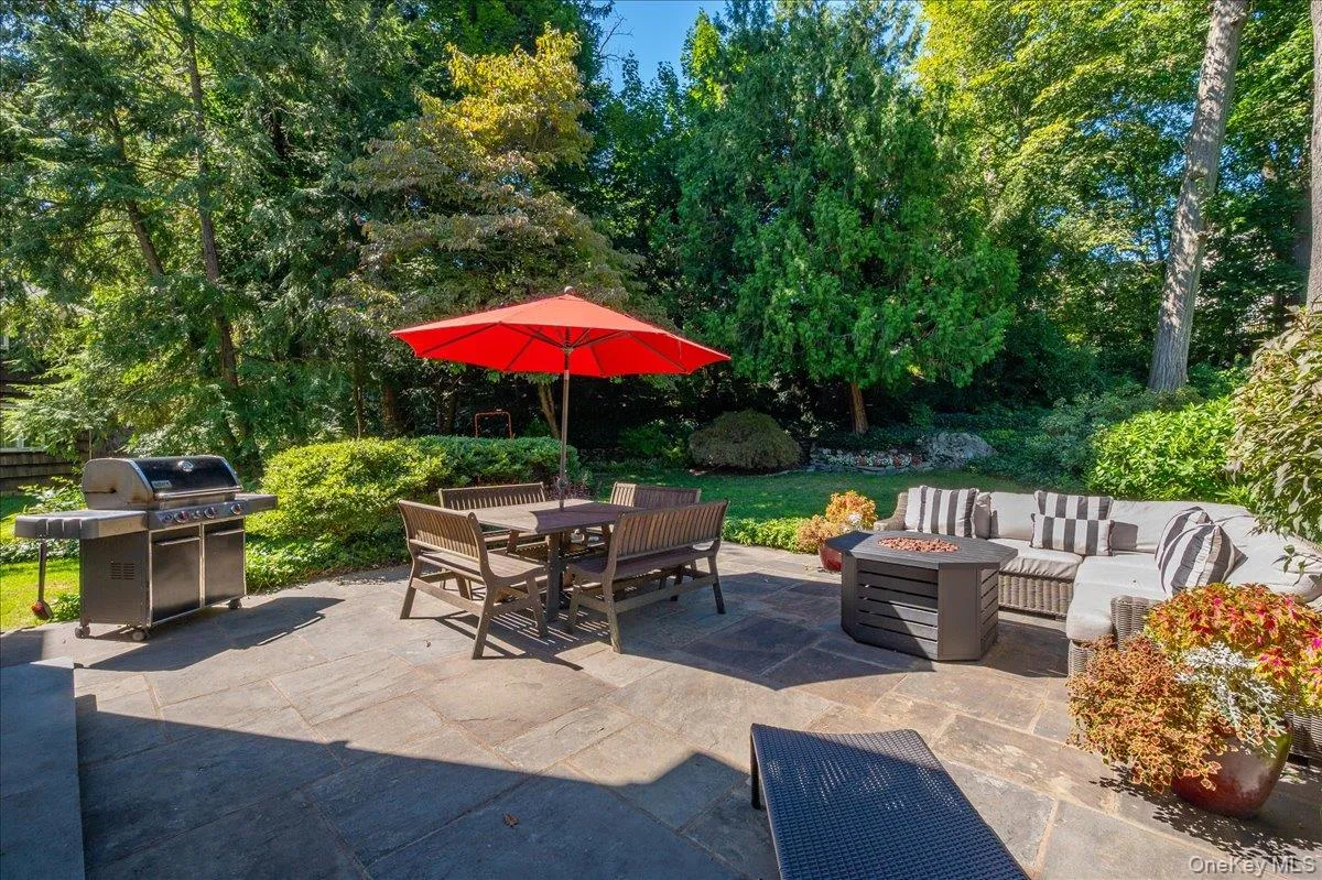 Comfortable patio seating overlooks the lush backyard, illustrating how naturally this home extends everyday living outdoors. Comfortable patio seating overlooks the lush backyard, illustrating how naturally this home extends everyday living outdoors.
