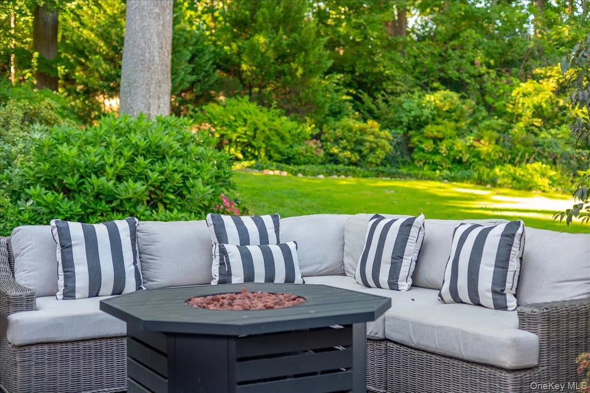 Comfortable patio seating overlooks the lush backyard, illustrating how naturally this home extends everyday living outdoors. Comfortable patio seating overlooks the lush backyard, illustrating how naturally this home extends everyday living outdoors.
