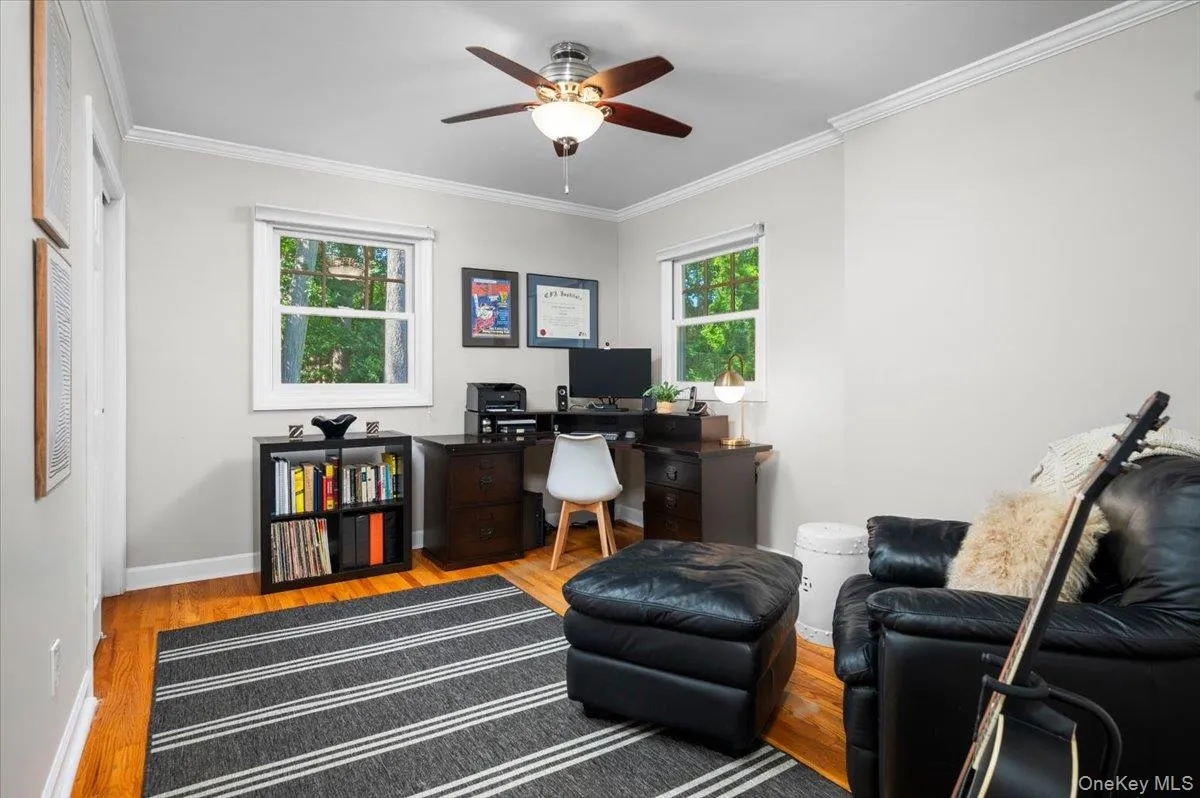 This flexible bedroom is shown as a comfortable office and sitting space, with hardwood floors, crown molding and windows on two sides. This flexible bedroom is shown as a comfortable office and sitting space, with hardwood floors, crown molding and windows on two sides.