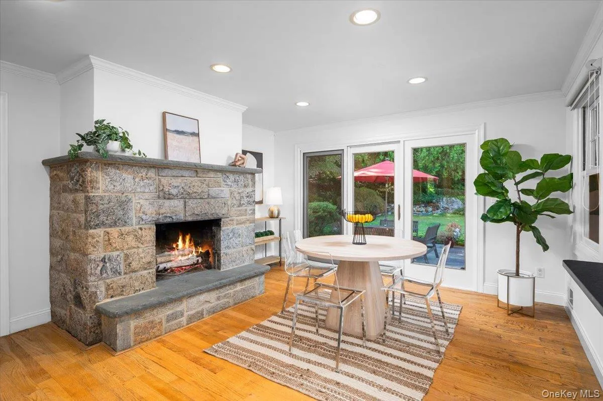 The family room or casual dining area form the heart of the home, anchored by a substantial stone wood-burning fireplace and direct access to the backyard. The family room or casual dining area form the heart of the home, anchored by a substantial stone wood-burning fireplace and direct access to the backyard.