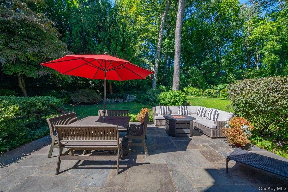 The expansive bluestone patio provides generous space for both dining and lounging, surrounded by mature landscaping and a level lawn. The expansive bluestone patio provides generous space for both dining and lounging, surrounded by mature landscaping and a level lawn.