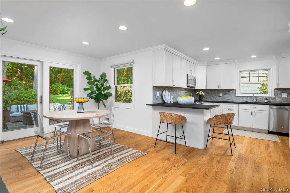 The renovated kitchen opens to casual dining and the family room, while sliders lead directly outside—an exceptionally functional progression from kitchen to living space to patio and yard. The renovated kitchen opens to casual dining and the family room, while sliders lead directly outside—an exceptionally functional progression from kitchen to living space to patio and yard.