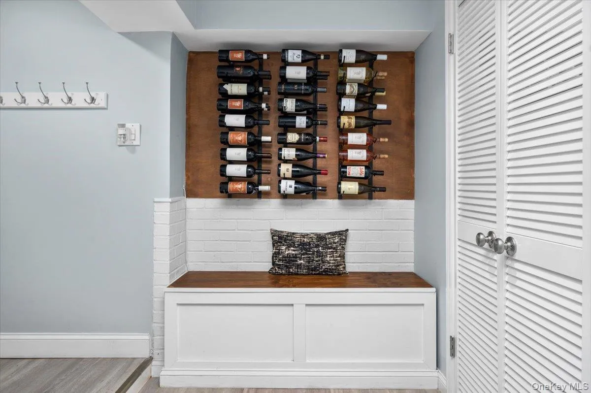 A custom bench in the mudroom area and a wall-mounted wine display add useful storage and character to the finished lower level. A custom bench in the mudroom area and a wall-mounted wine display add useful storage and character to the finished lower level.