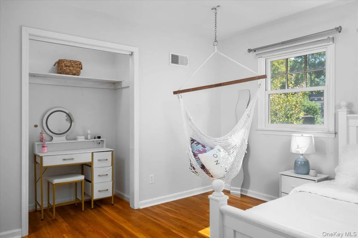 One of the bedroom's 2 closets is configured as a useful desk area, demonstrating how efficiently the home’s bedroom spaces can adapt to everyday needs. One of the bedroom's 2 closets is configured as a useful desk area, demonstrating how efficiently the home’s bedroom spaces can adapt to everyday needs.