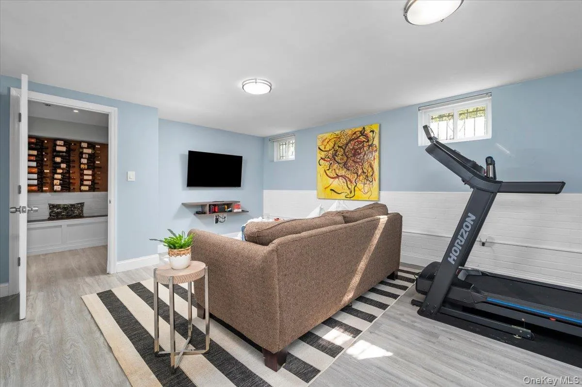 A second view shows the lower level’s generous footprint and ability to accommodate several uses at once; an additional full bath further enhances the versatility of this floor. A second view shows the lower level’s generous footprint and ability to accommodate several uses at once; an additional full bath further enhances the versatility of this floor.