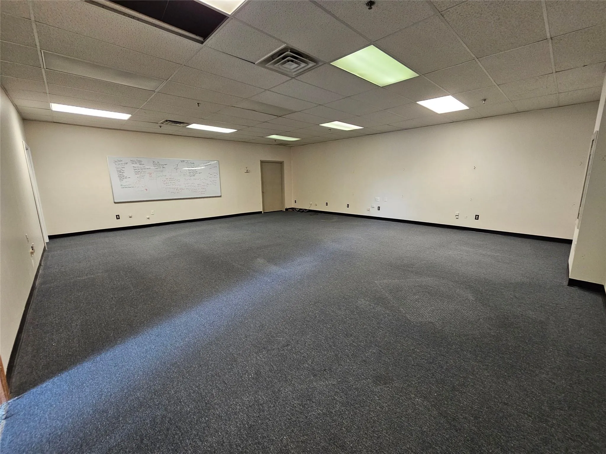 Unfurnished room with a paneled ceiling and baseboards Unfurnished room with a paneled ceiling and baseboards