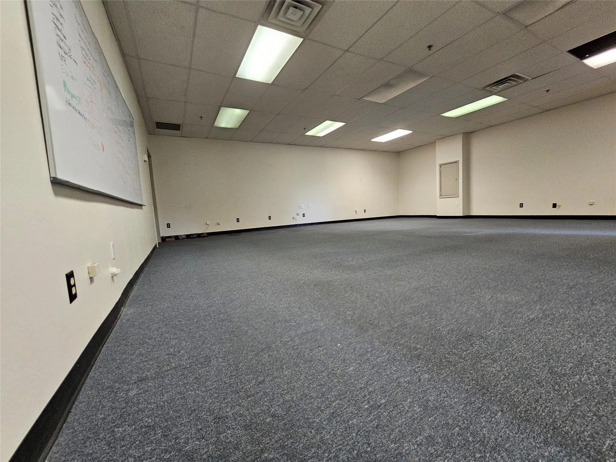 Unfurnished room featuring a drop ceiling and baseboards Unfurnished room featuring a drop ceiling and baseboards