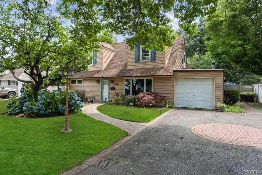 View of front of house with asphalt driveway, a garage, and roof with shingles View of front of house with asphalt driveway, a garage, and roof with shingles
