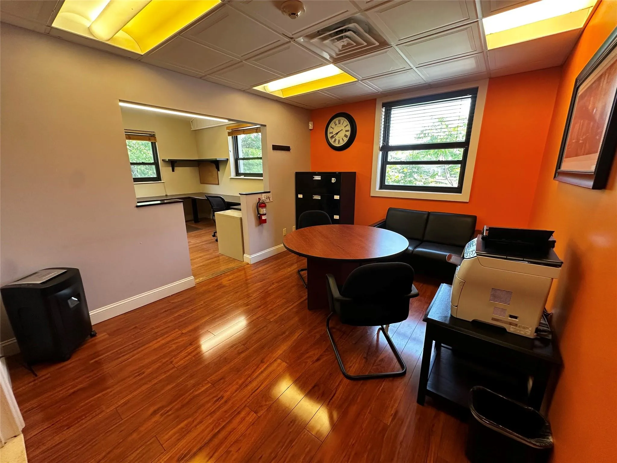 Living room featuring wood finished floors, an office area, and an ornate ceiling Living room featuring wood finished floors, an office area, and an ornate ceiling