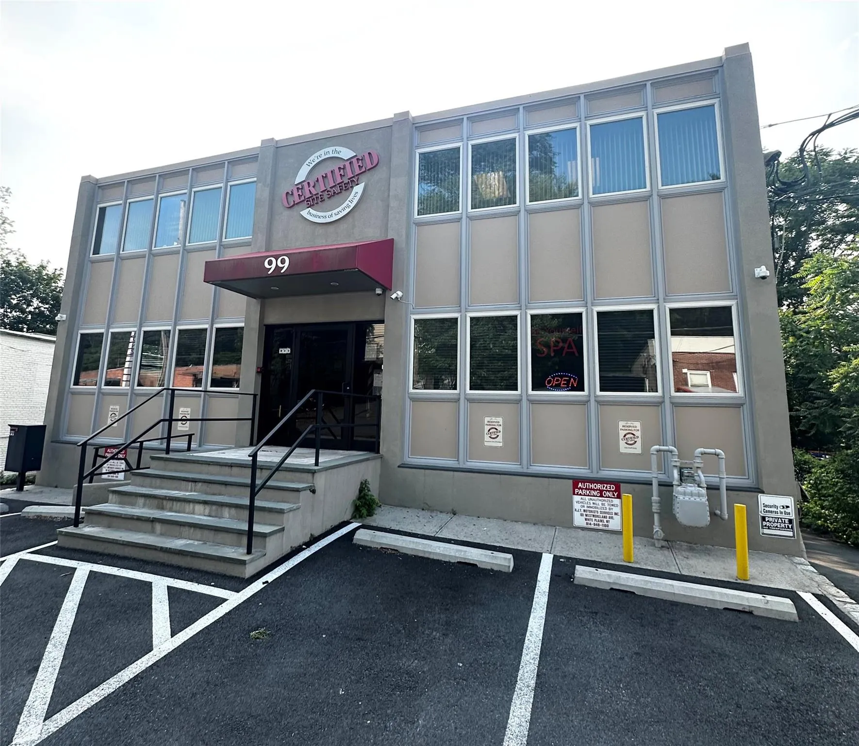 View of building exterior featuring uncovered parking View of building exterior featuring uncovered parking