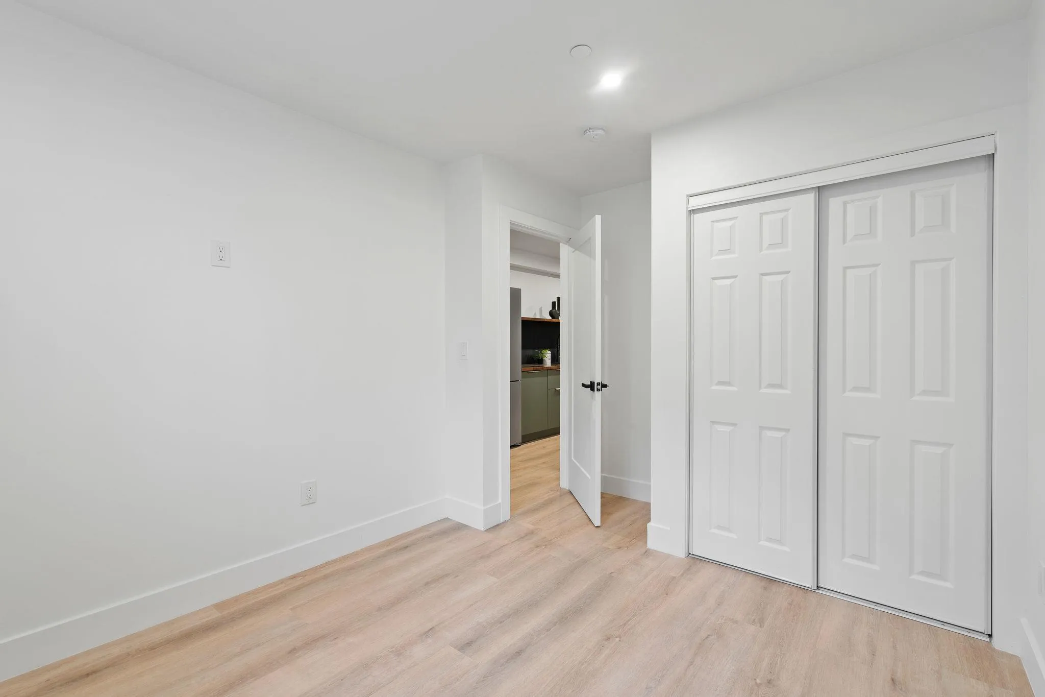Unfurnished bedroom with light hardwood / wood-style floors and a closet Unfurnished bedroom with light hardwood / wood-style floors and a closet