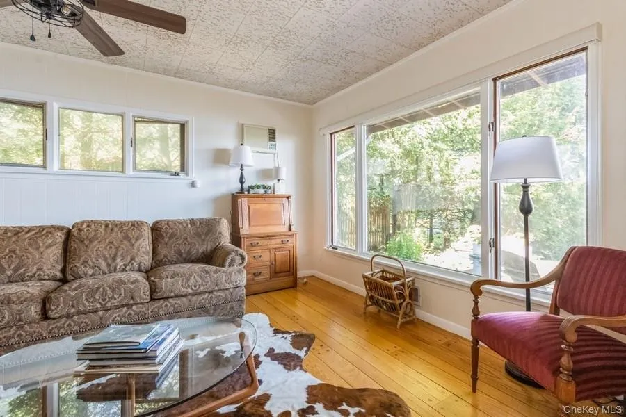 sitting room with light wood flooring, and ceiling fan sitting room with light wood flooring, and ceiling fan