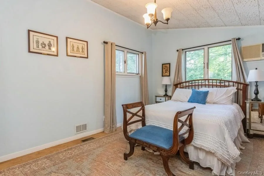 Bedroom with a chandelier and vaulted ceiling Bedroom with a chandelier and vaulted ceiling
