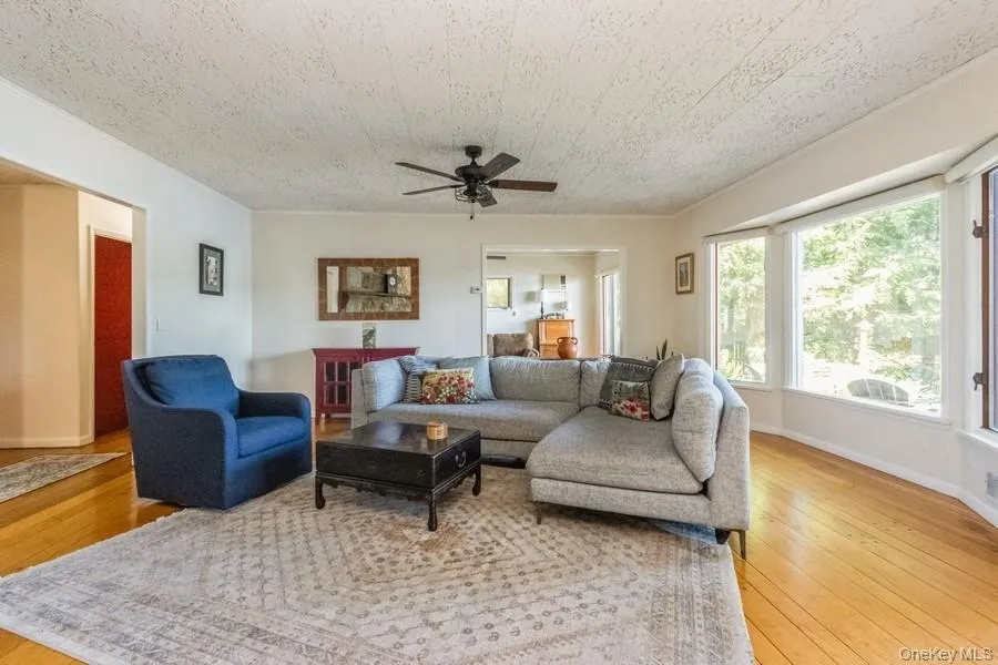 Living area with light wood finished floors and ceiling fan Living area with light wood finished floors and ceiling fan
