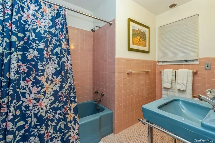 Bathroom with tile walls, and shower / tub combo Bathroom with tile walls, and shower / tub combo