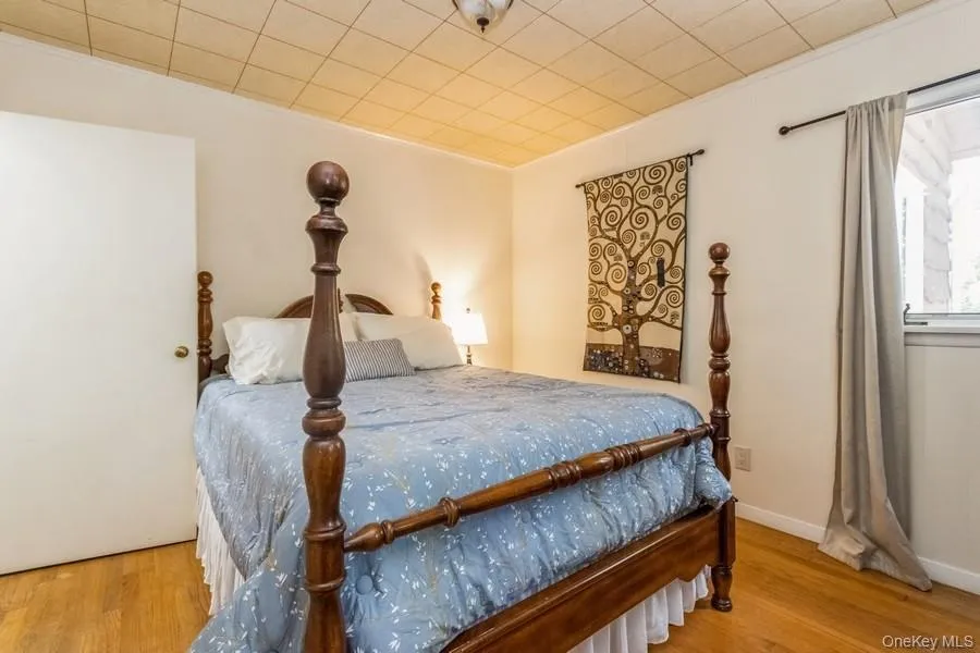 Bedroom featuring wood finished floors Bedroom featuring wood finished floors