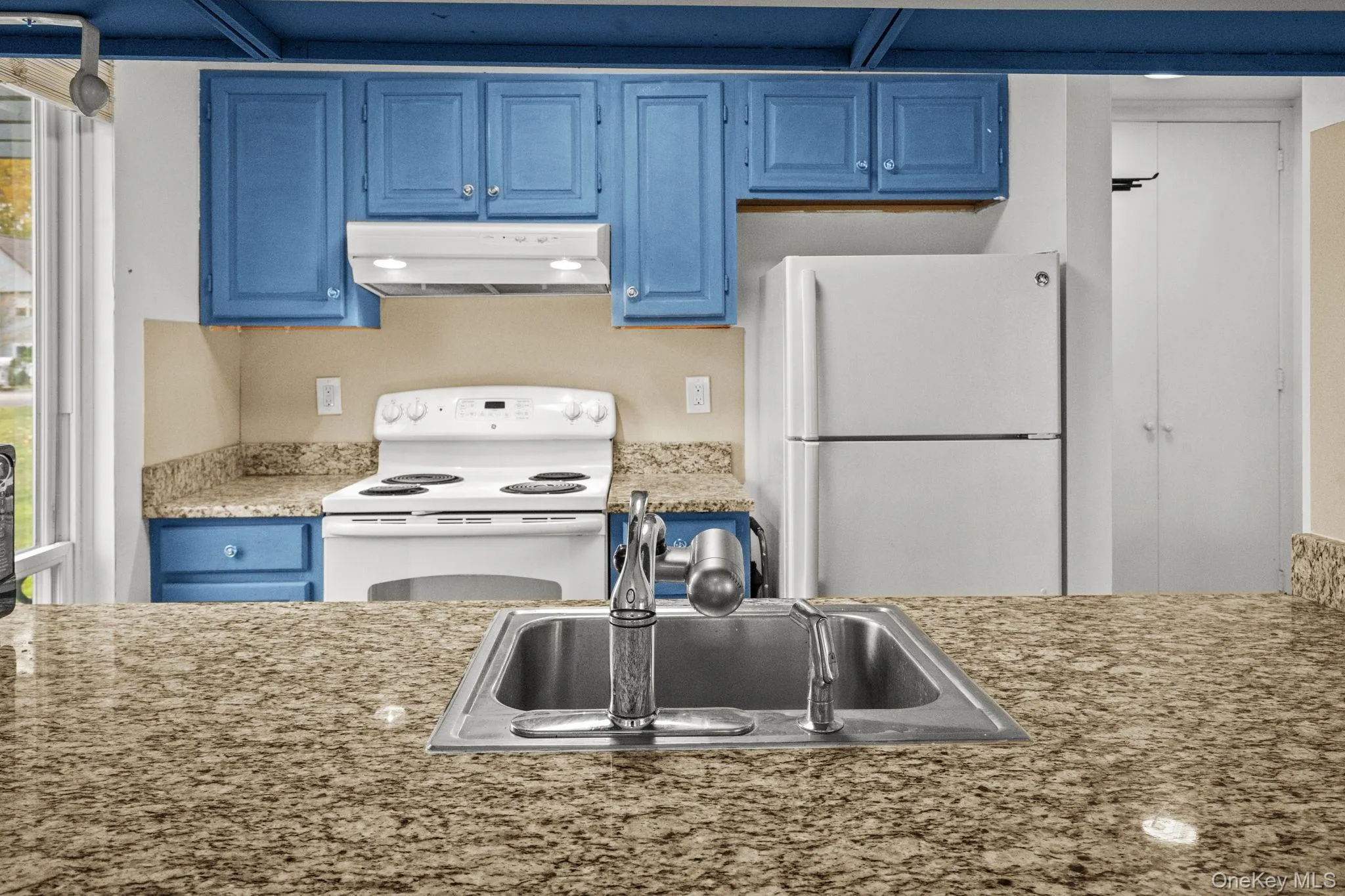 A granite breakfast bar and crisp cabinetry create a functional kitchen layout ideal for cooking and entertaining. A granite breakfast bar and crisp cabinetry create a functional kitchen layout ideal for cooking and entertaining.