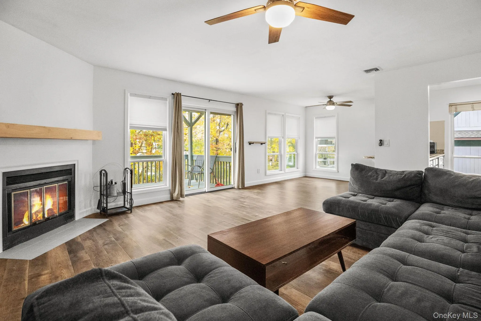 Sliding doors fill the open-concept living and dining area with natural light and lead directly to the private deck. Sliding doors fill the open-concept living and dining area with natural light and lead directly to the private deck.