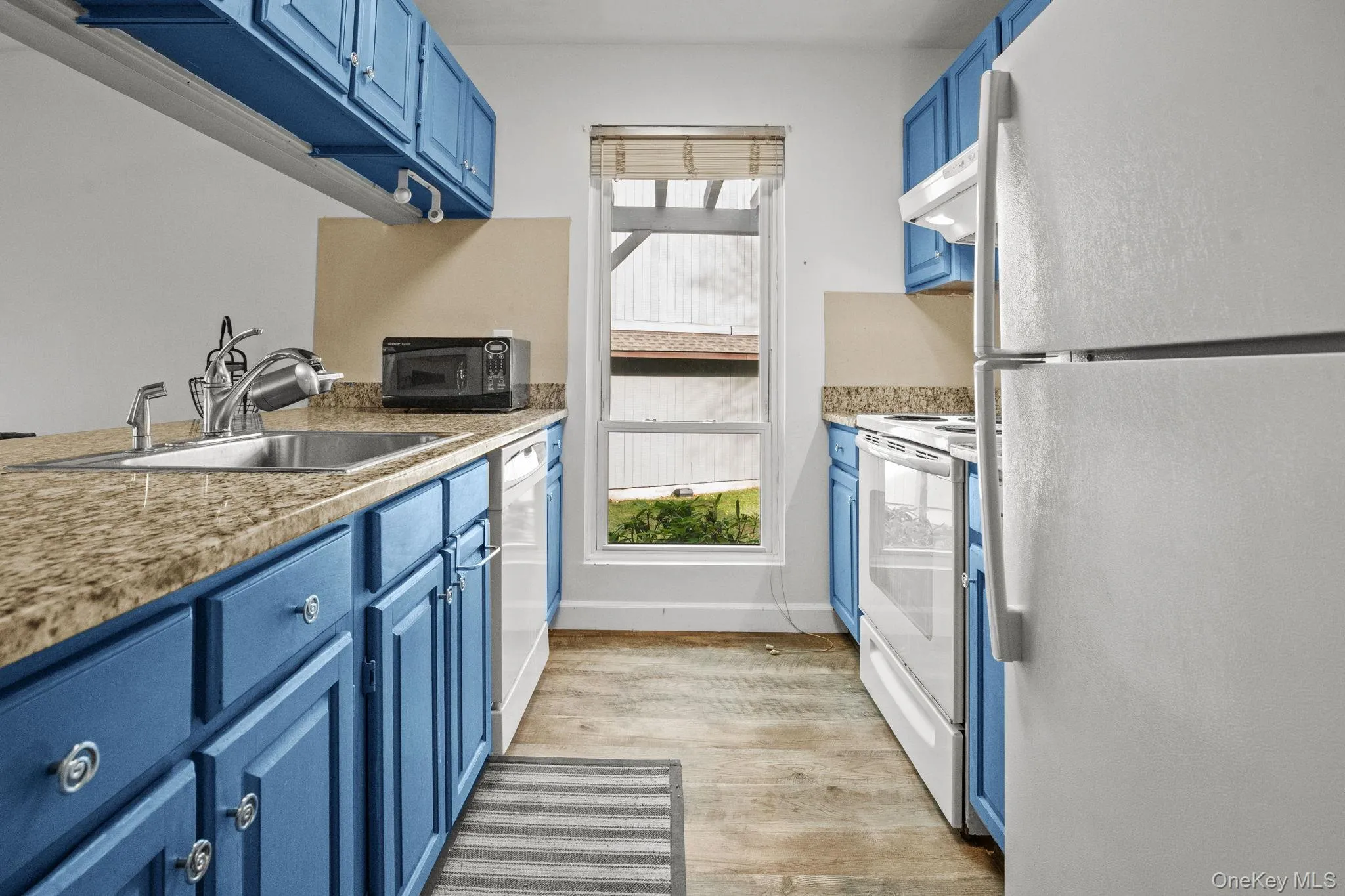 The updated kitchen features granite countertops, ample cabinetry, and a window that brings in beautiful natural light. The updated kitchen features granite countertops, ample cabinetry, and a window that brings in beautiful natural light.