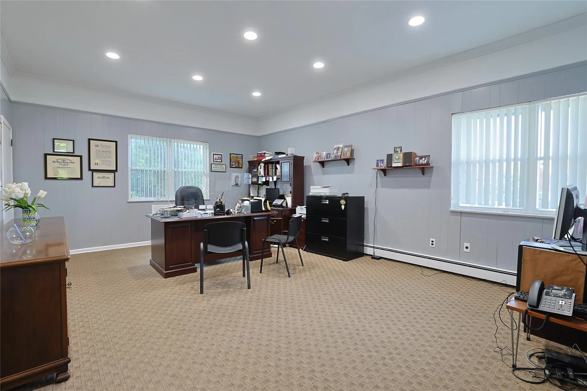 Carpeted office space featuring crown molding, a baseboard radiator, and recessed lighting Carpeted office space featuring crown molding, a baseboard radiator, and recessed lighting
