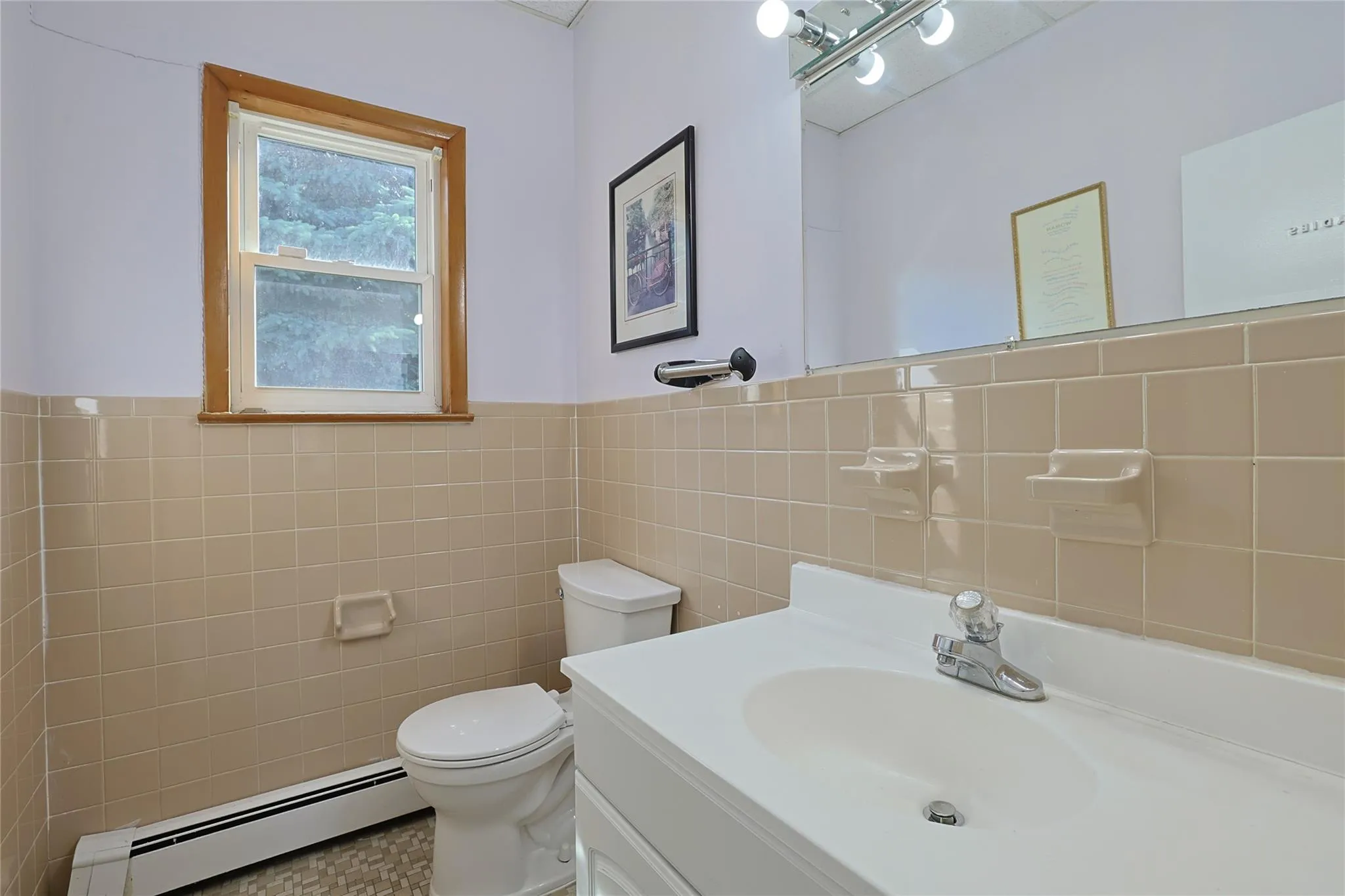 Bathroom featuring a baseboard radiator, tile walls, vanity, and a wainscoted wall Bathroom featuring a baseboard radiator, tile walls, vanity, and a wainscoted wall