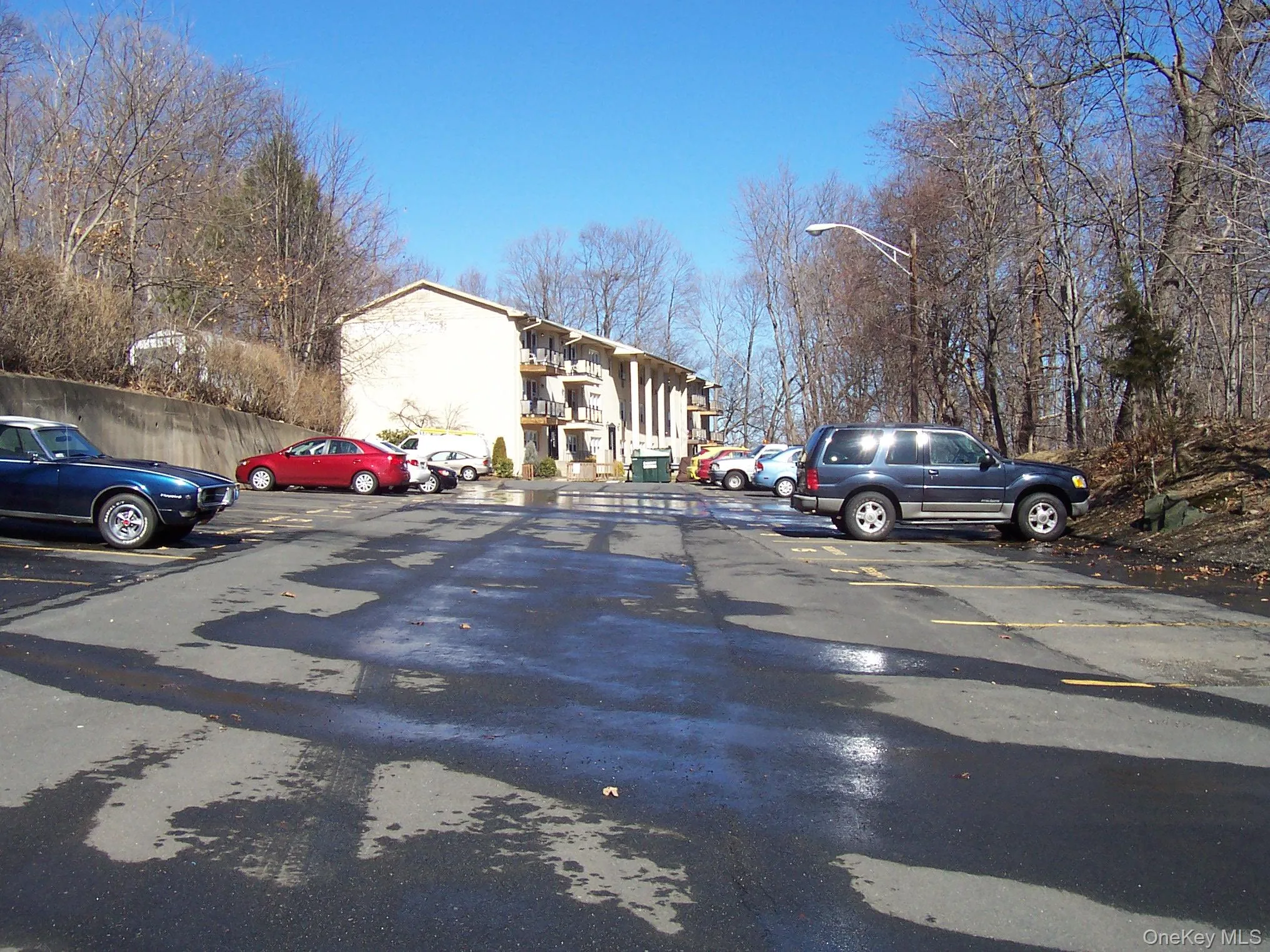 View of asphalt road featuring street lights View of asphalt road featuring street lights
