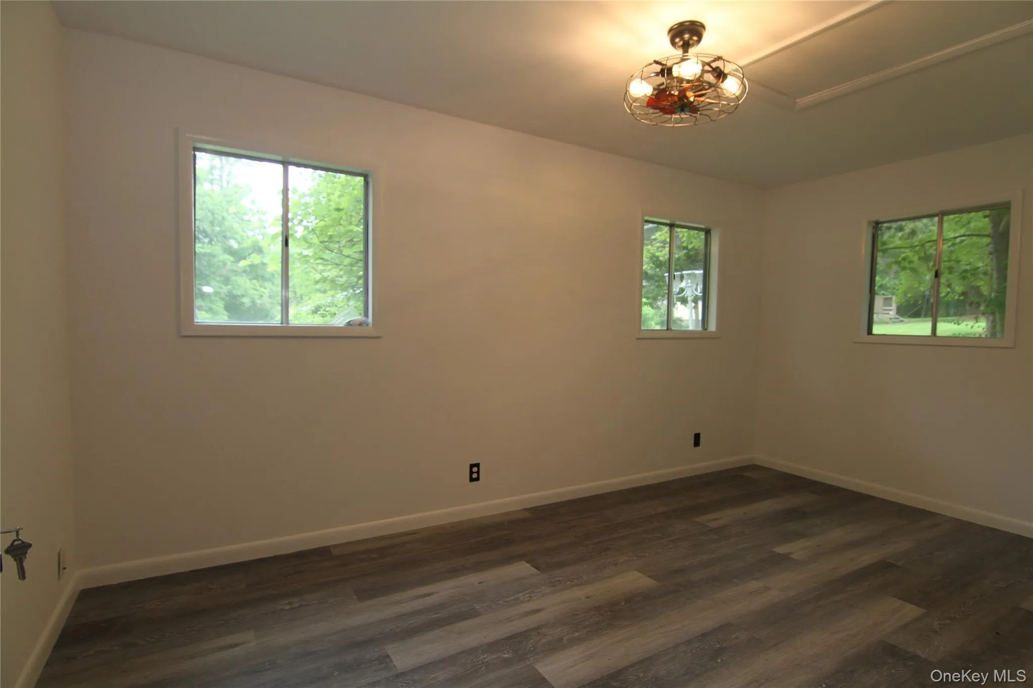Spare room with dark wood-type flooring Spare room with dark wood-type flooring