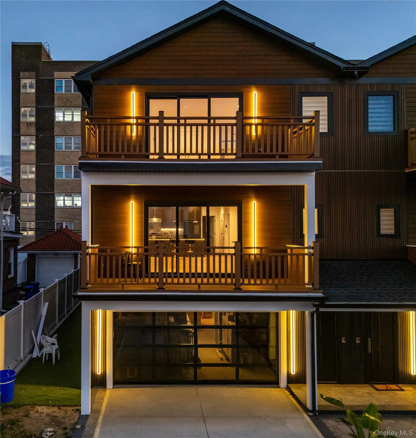 Modern home with a garage, driveway, and a balcony Modern home with a garage, driveway, and a balcony