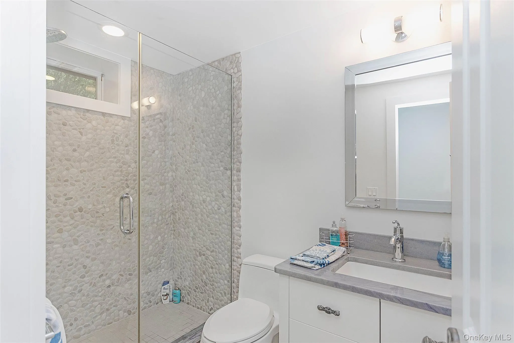 Full bath featuring vanity and a stall shower Full bath featuring vanity and a stall shower