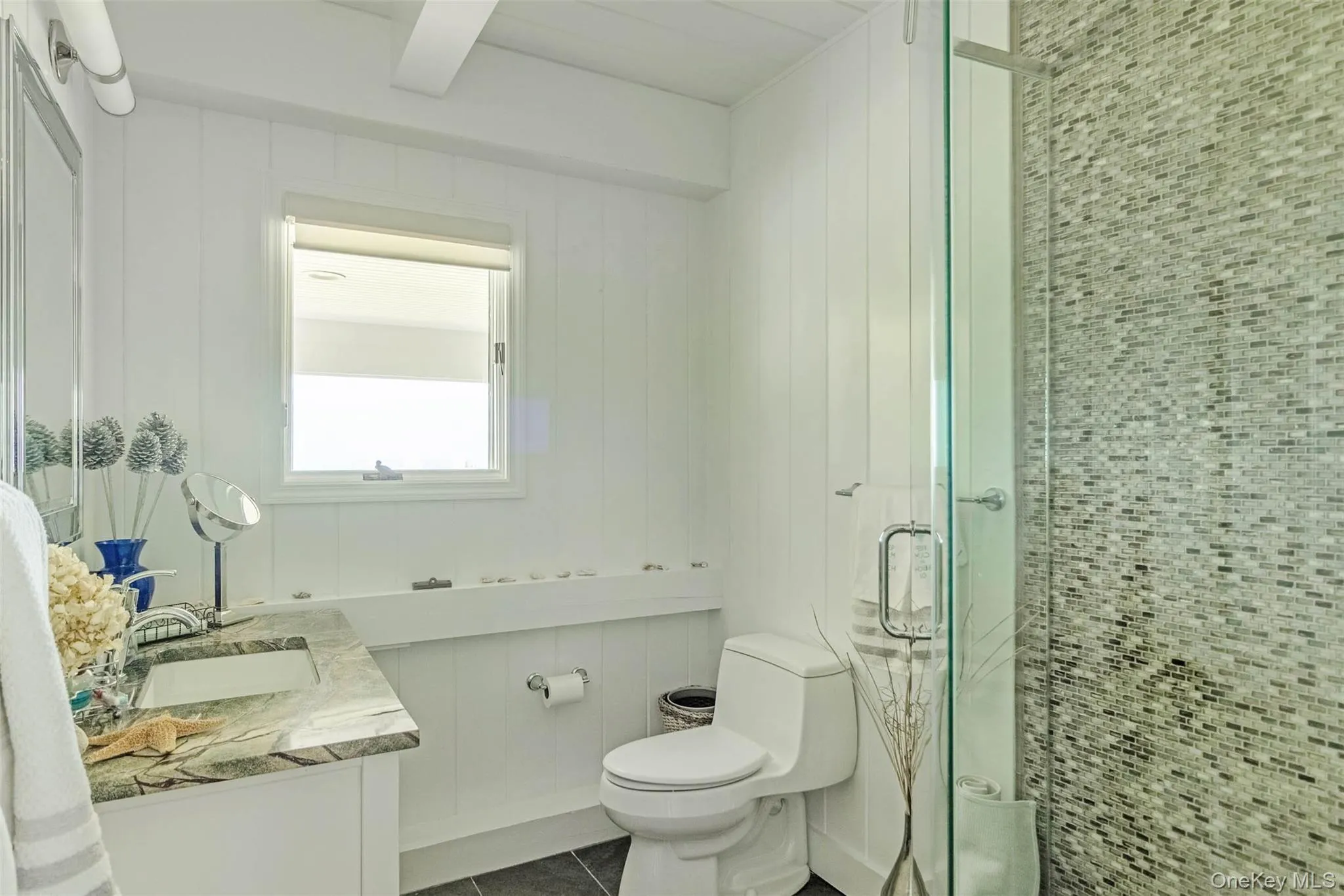 Bathroom with a stall shower, vanity, and tile patterned floors Bathroom with a stall shower, vanity, and tile patterned floors