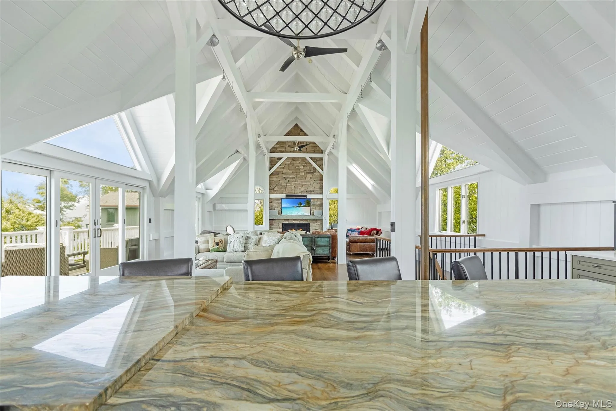 Dining area with ceiling fan, a fireplace, and french doors Dining area with ceiling fan, a fireplace, and french doors