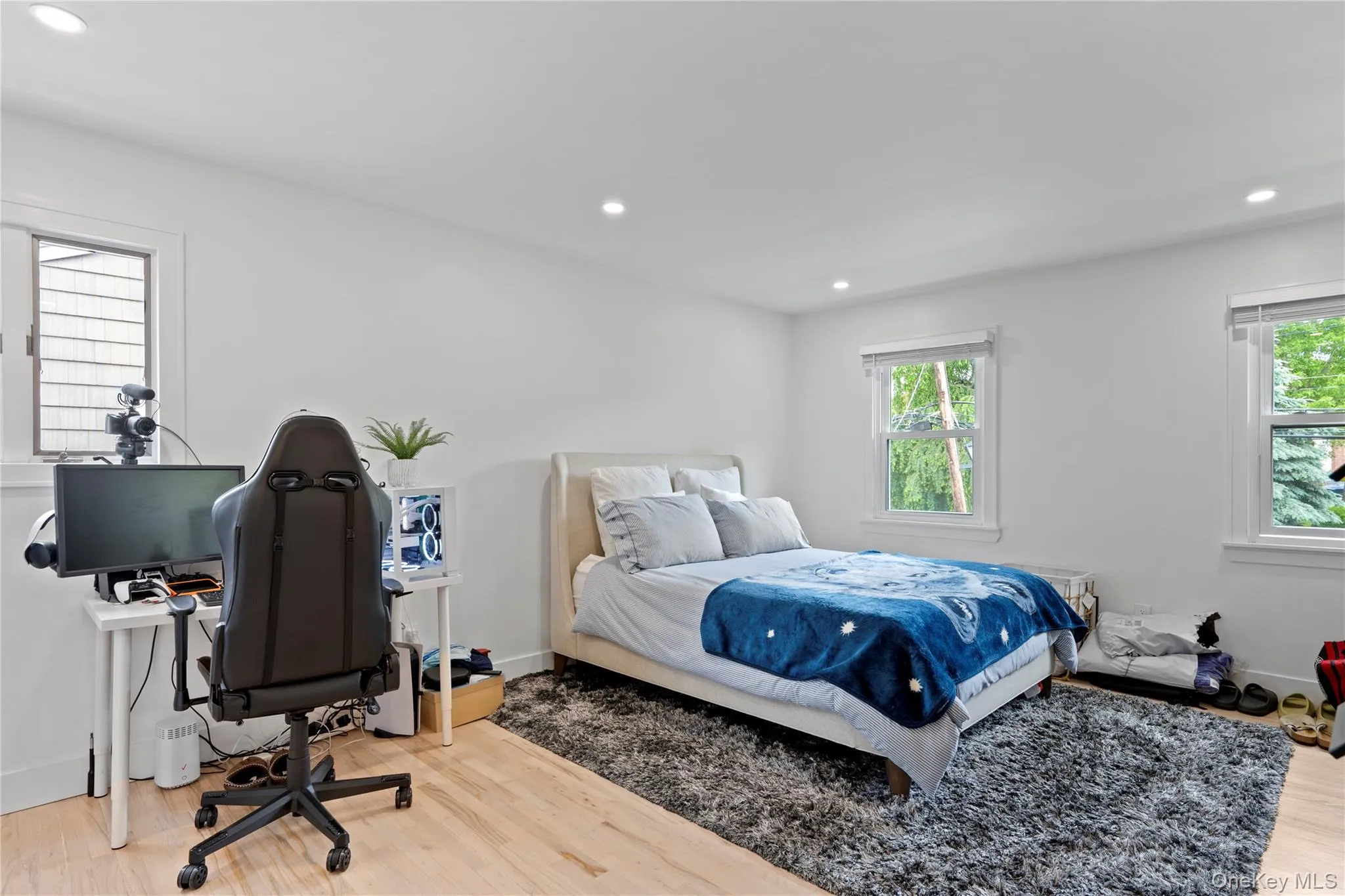 Bedroom featuring multiple windows, wood finished floors, and recessed lighting Bedroom featuring multiple windows, wood finished floors, and recessed lighting
