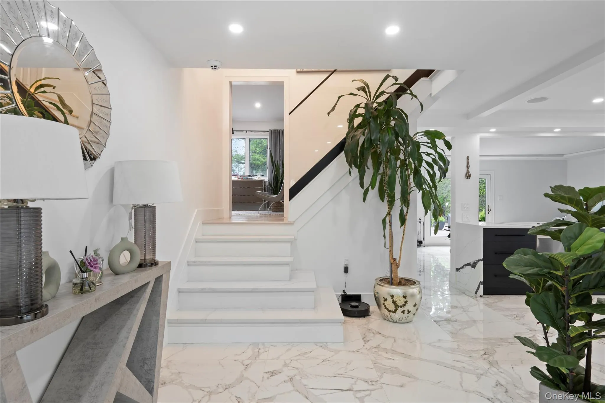 Staircase with marble finish floors and recessed lighting Staircase with marble finish floors and recessed lighting