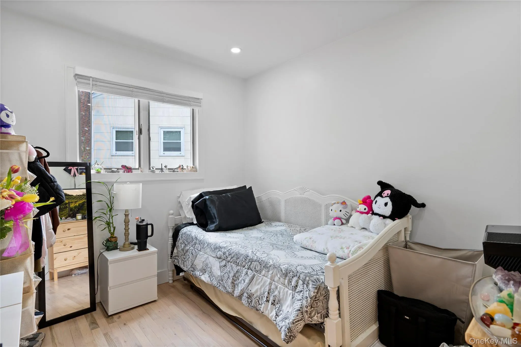 Bedroom featuring light wood-style floors and recessed lighting Bedroom featuring light wood-style floors and recessed lighting
