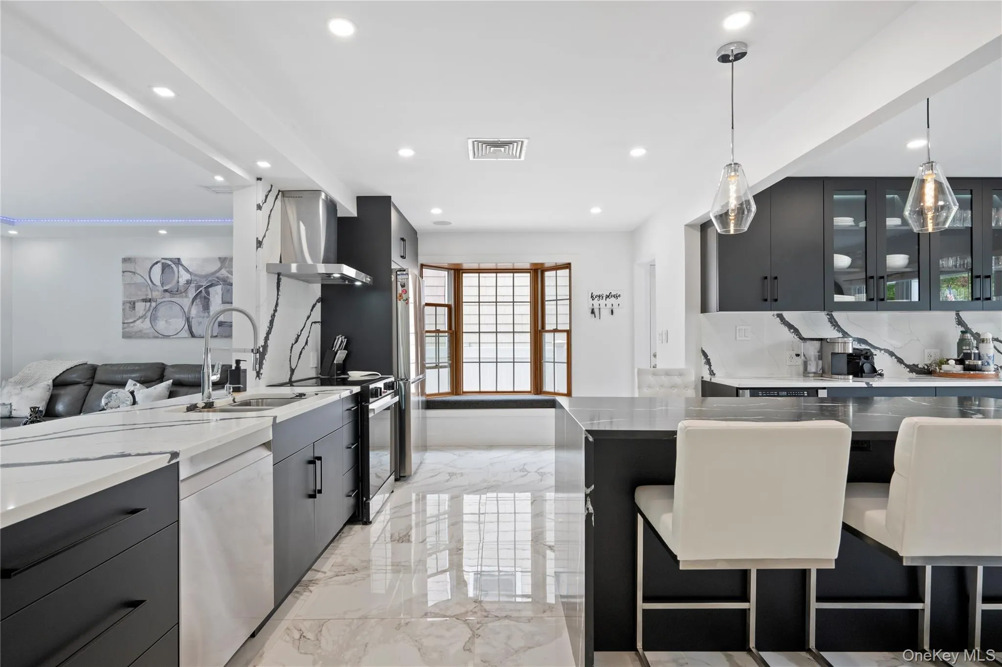 Kitchen with island range hood, dishwasher, electric range, light marble finish floors, and recessed lighting Kitchen with island range hood, dishwasher, electric range, light marble finish floors, and recessed lighting