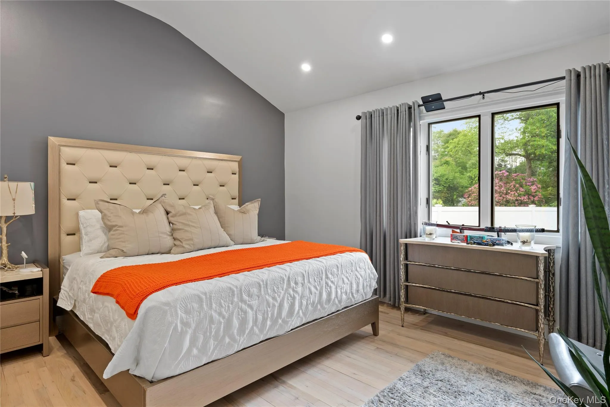 Bedroom featuring vaulted ceiling, light wood-type flooring, and recessed lighting Bedroom featuring vaulted ceiling, light wood-type flooring, and recessed lighting