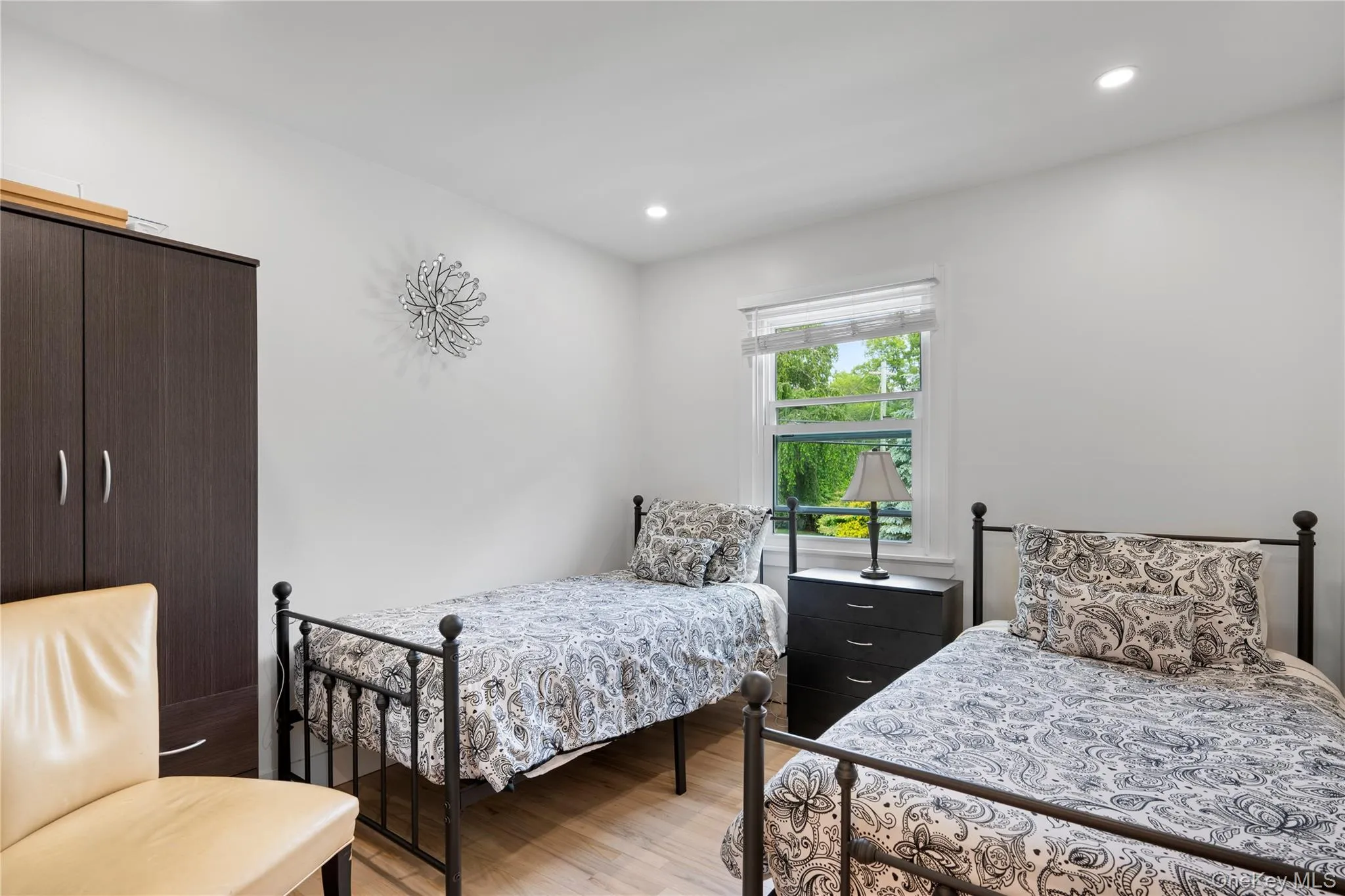Bedroom with light wood finished floors and recessed lighting Bedroom with light wood finished floors and recessed lighting