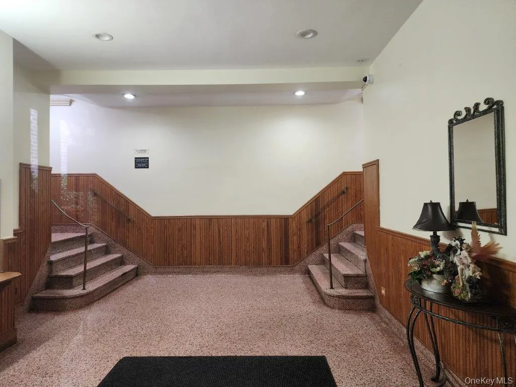 Staircase with a wainscoted wall, wooden walls, and recessed lighting Staircase with a wainscoted wall, wooden walls, and recessed lighting