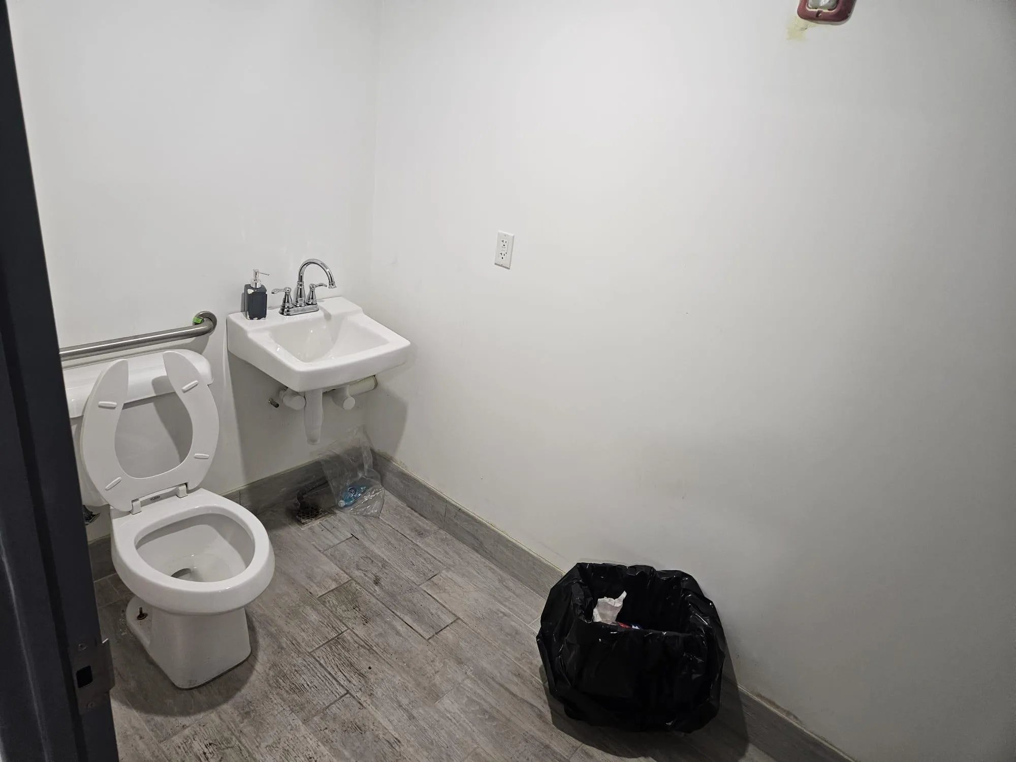 Half bathroom featuring toilet and wood finished floors Half bathroom featuring toilet and wood finished floors