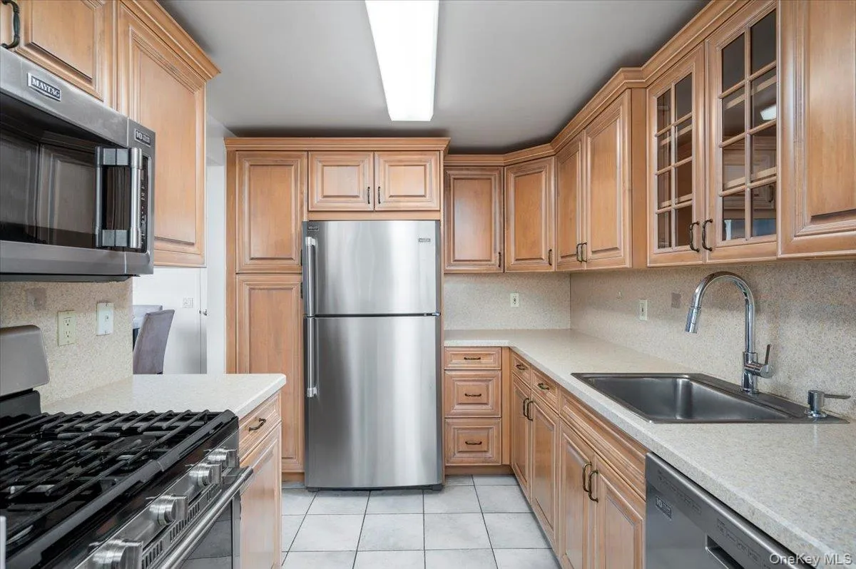 Kitchen with stainless steel appliances appliances, light countertops, and ample storage Kitchen with stainless steel appliances appliances, light countertops, and ample storage