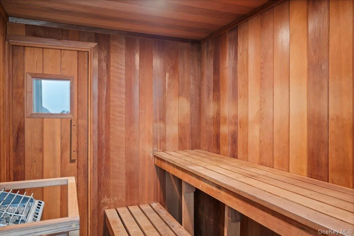 Sauna / steam room featuring wood ceiling and wood walls Sauna / steam room featuring wood ceiling and wood walls