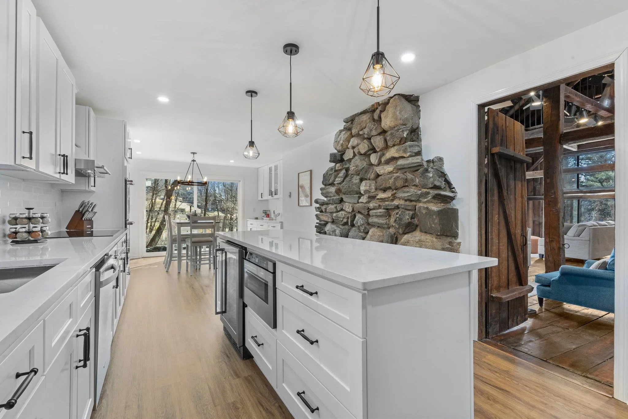 Kitchen with light wood-type flooring, healthy amount of natural light, white cabinets, and recessed lighting Kitchen with light wood-type flooring, healthy amount of natural light, white cabinets, and recessed lighting