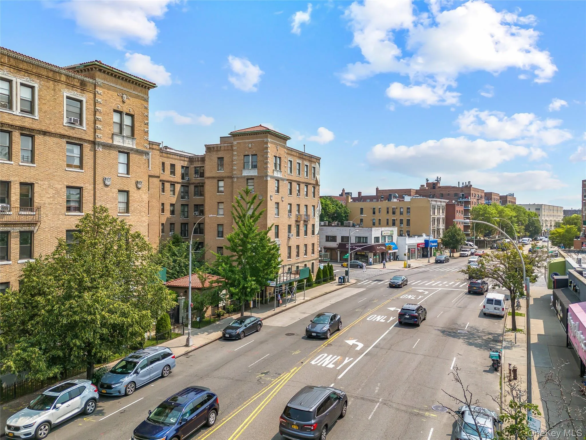 View of building exterior with uncovered parking and a view of city View of building exterior with uncovered parking and a view of city