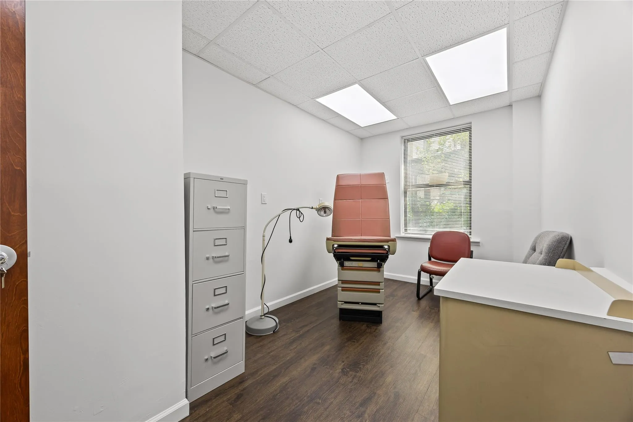 Home office featuring dark wood-style flooring and a paneled ceiling Home office featuring dark wood-style flooring and a paneled ceiling
