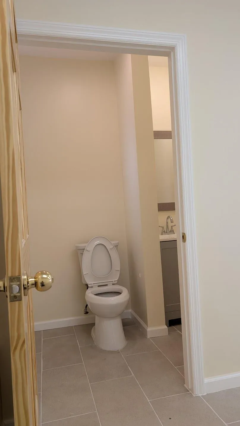 Half bathroom with tile patterned flooring and vanity Half bathroom with tile patterned flooring and vanity