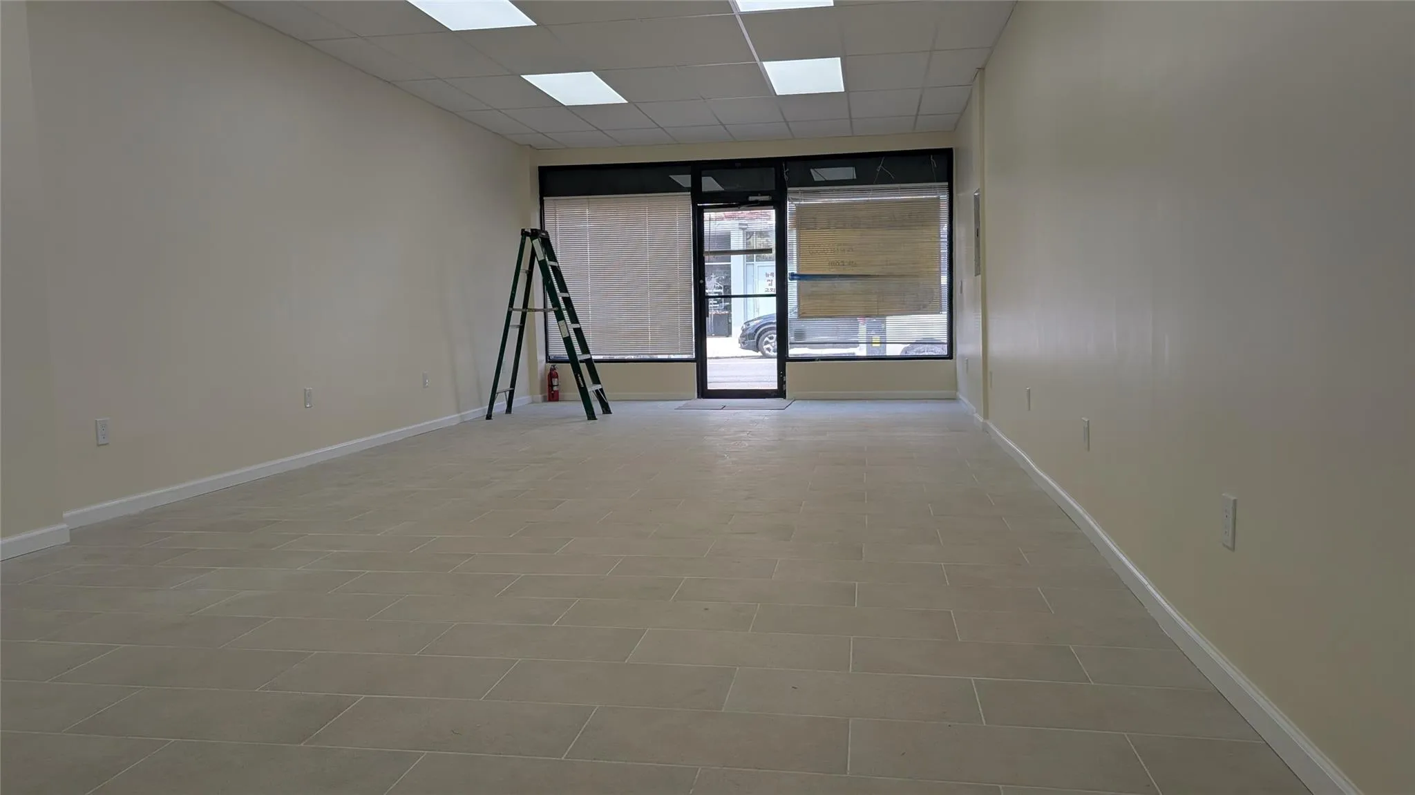 Unfurnished room with a drop ceiling and baseboards Unfurnished room with a drop ceiling and baseboards