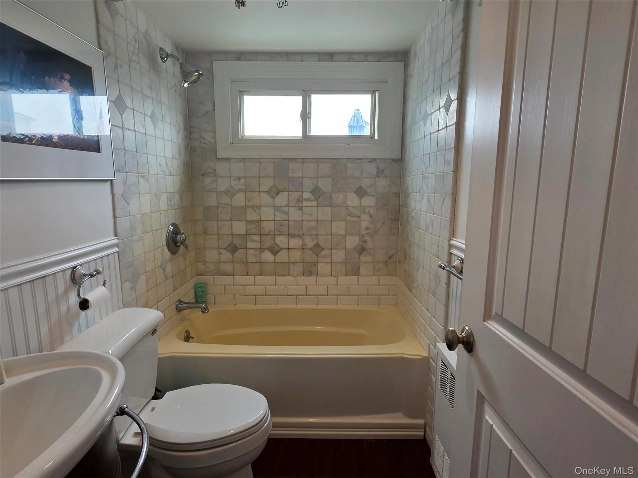 Bathroom featuring toilet and shower / bathtub combination Bathroom featuring toilet and shower / bathtub combination