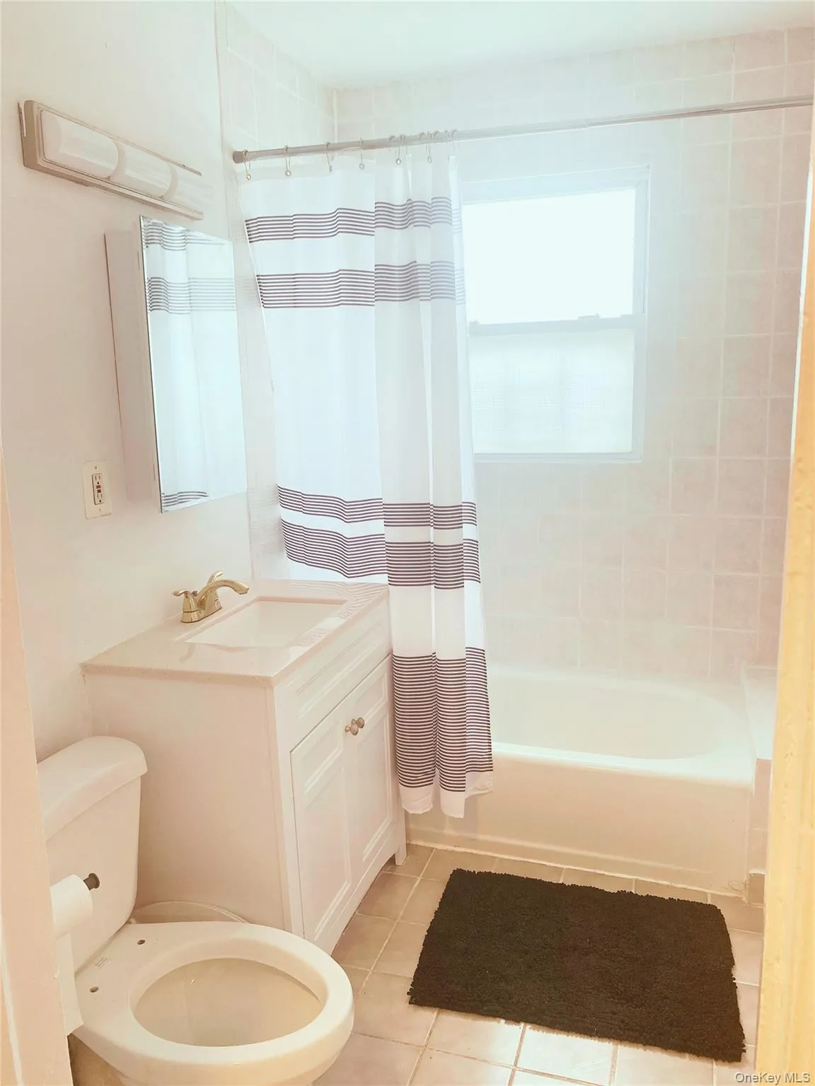 Full bath with tile patterned flooring, shower / tub combo, and vanity Full bath with tile patterned flooring, shower / tub combo, and vanity