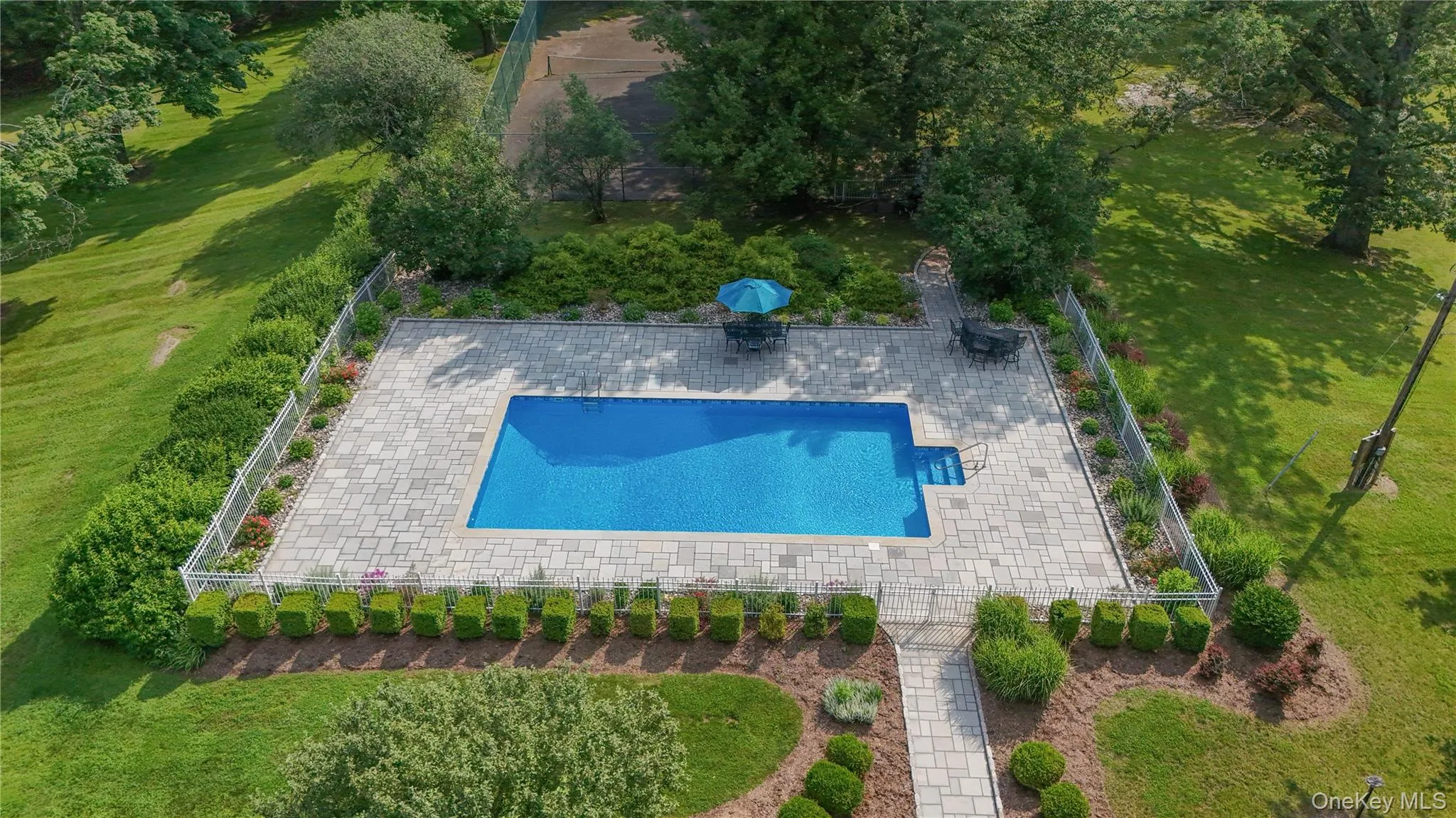 Elevated view of the pool and tennis court Elevated view of the pool and tennis court